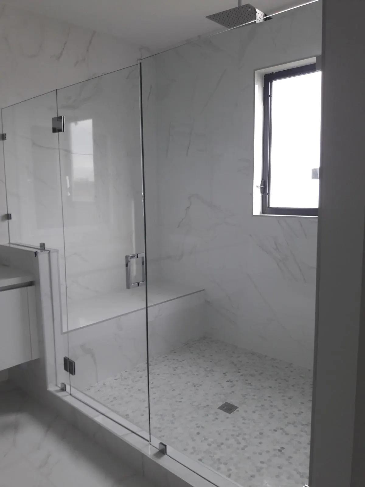 Bathroom remodel with marble glass shower in Miami, FL