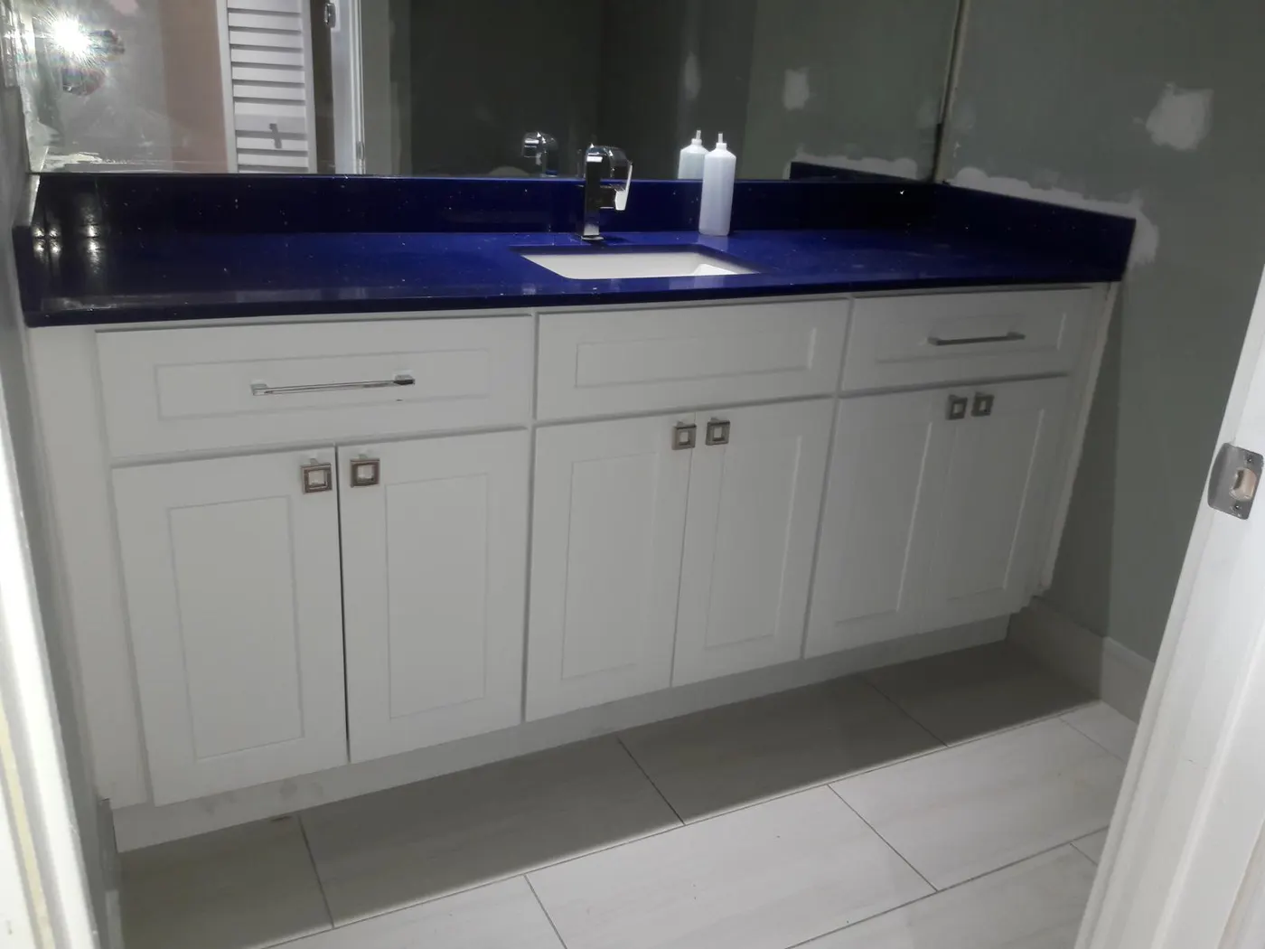 Bathroom remodel with navy quartz vanity in West Palm Beach, FL