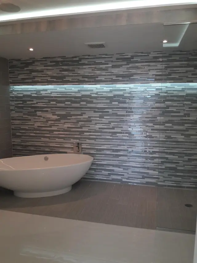 Bathroom remodel with mosaic tile shower and freestanding tub