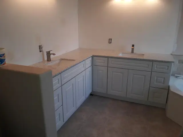 Kitchen with marble backsplash and garden window view