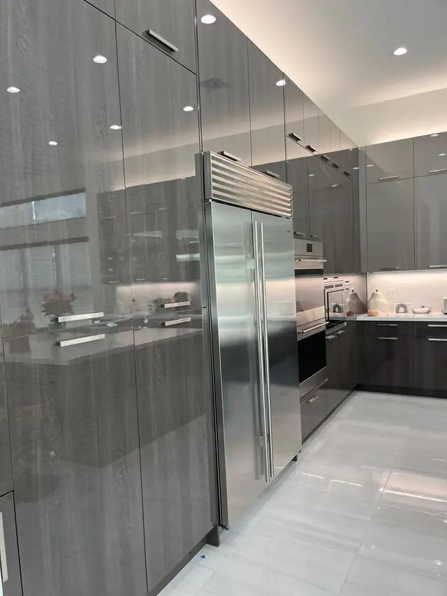 High-gloss gray kitchen remodel with stainless appliances