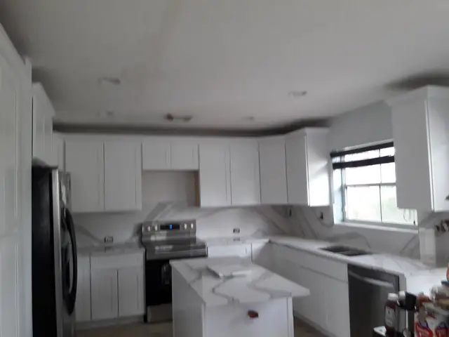 White kitchen remodel with wood flooring