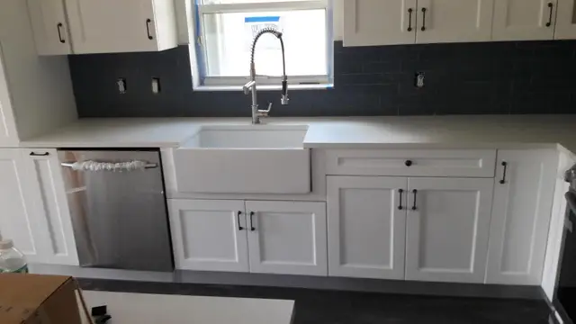 White kitchen with navy subway tile backsplash